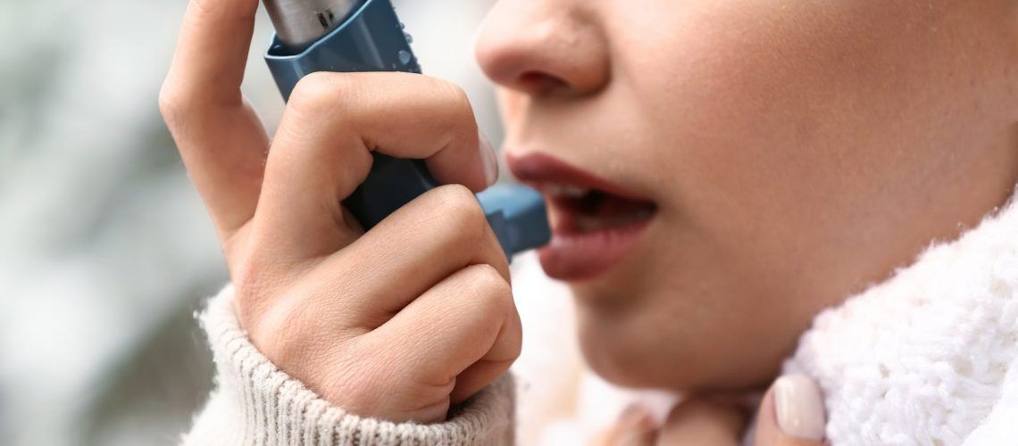 Woman using Asthma inhaler